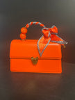 Orange Vegan clutch with pear and ribbon handle