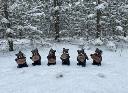 Resin Black Bear holding message sign