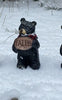 Resin Black Bear holding message sign