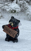 Resin Black Bear holding message sign