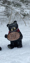 Resin Black Bear holding message sign
