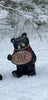 Resin Black Bear holding message sign