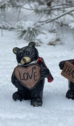 Resin Black Bear holding message sign