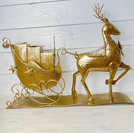 Golden metal deer pulling sleigh