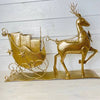Golden metal deer pulling sleigh